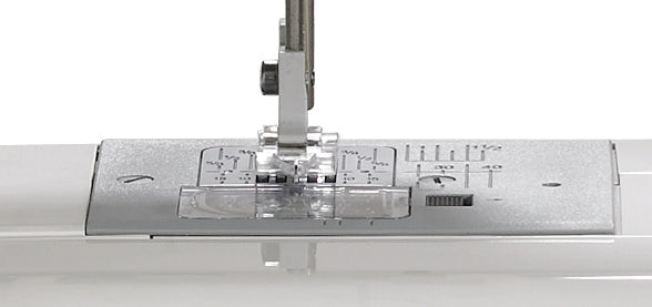 close up image of the Janome DC1050 Sewing Machine needle plate